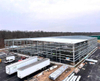 2025 Warehouse Storage Expansion Update Progress First Section Sheeted, 10 Doors Installed, Roof Bands and Cables in Place