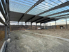 2025 Warehouse Expansion Update the Roof Sheeting Two Bays Left Ridge Caps Are Being Added and Sidewall Sheeting Is Underway