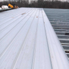 2025 Warehouse Storage Expansion Update Progress First Section Sheeted, 10 Doors Installed, Roof Bands and Cables in Place