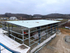 2025 Warehouse Expansion Update the Roof Sheeting Two Bays Left Ridge Caps Are Being Added and Sidewall Sheeting Is Underway