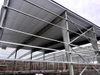 2025 Warehouse Storage Expansion Update Progress First Section Sheeted, 10 Doors Installed, Roof Bands and Cables in Place